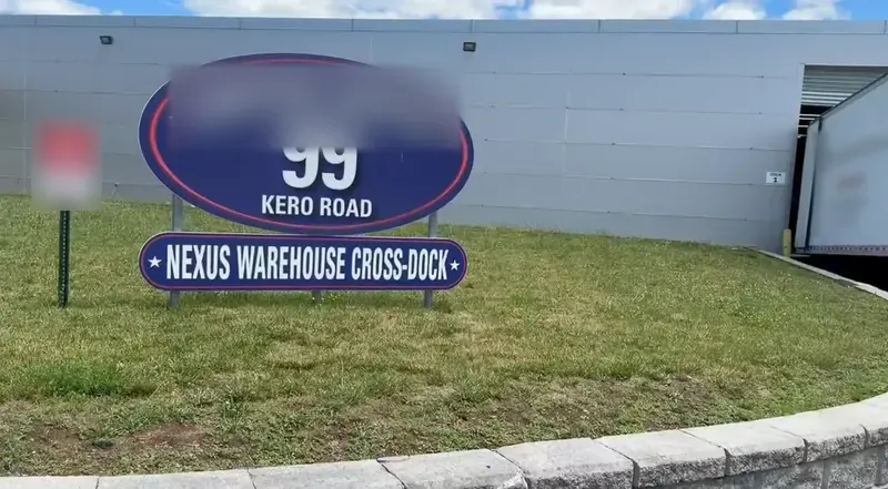 The Nexus Warehouse Cross-Dock sign at 99 Kero Rd, Carlstadt, NJ, beside dock door 1